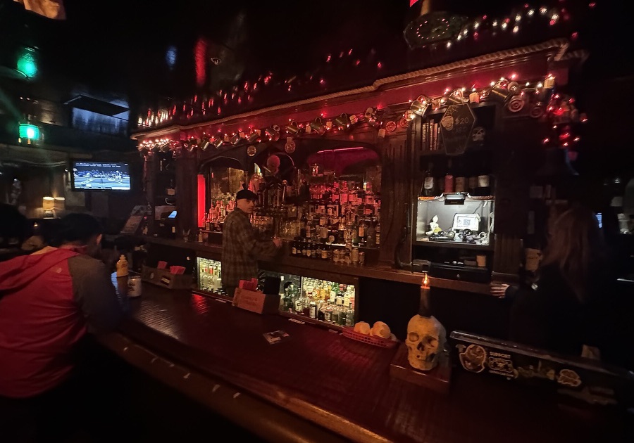 The bar at The Redwood Bar & Grill in downtown Los Angeles, lit with red holiday lights